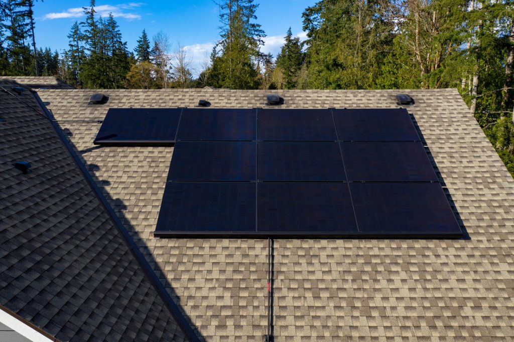 solar photovoltaic array generating electricity from the sun in eastside residential rooftop