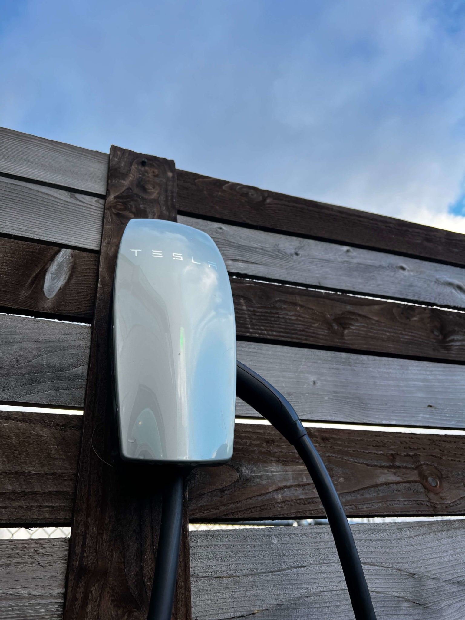 Tesla EV Charger installed outside on wooden post in the pacific northwest