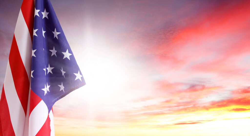 American flag with sunset backdrop