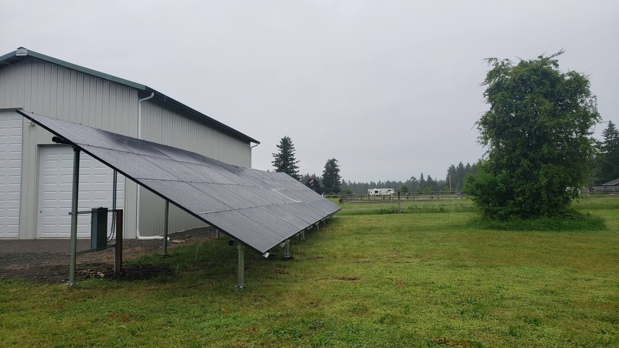 Ground-mount solar array next to barn