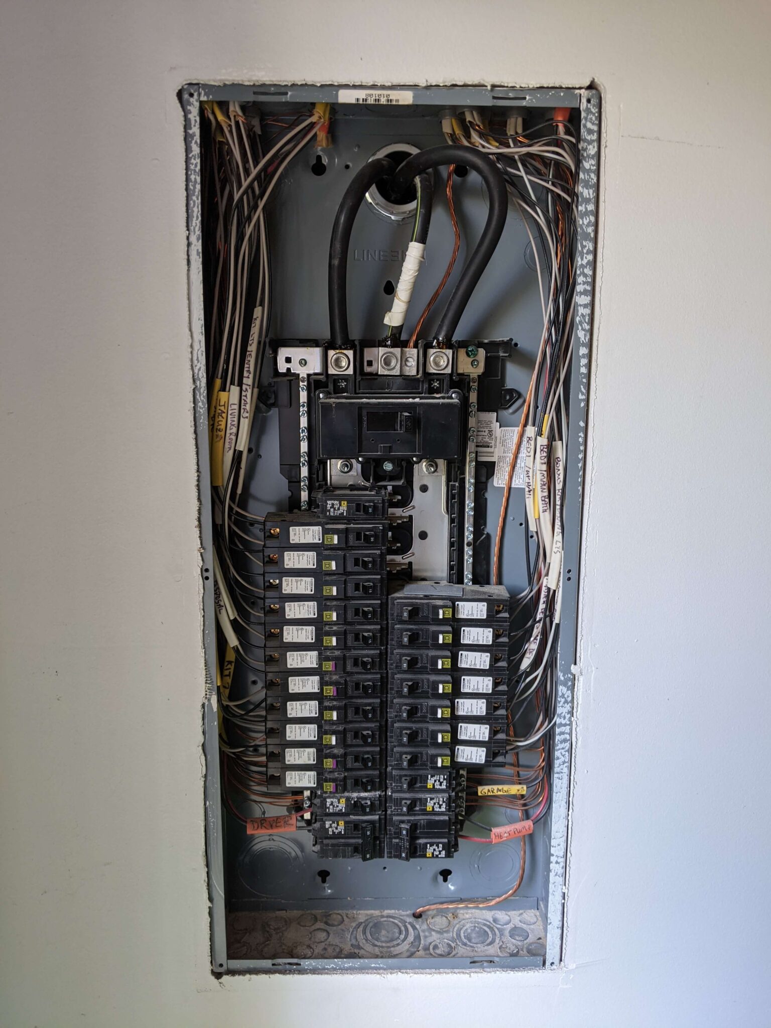 Breakers and electrical panel shown with the cover off in Washington